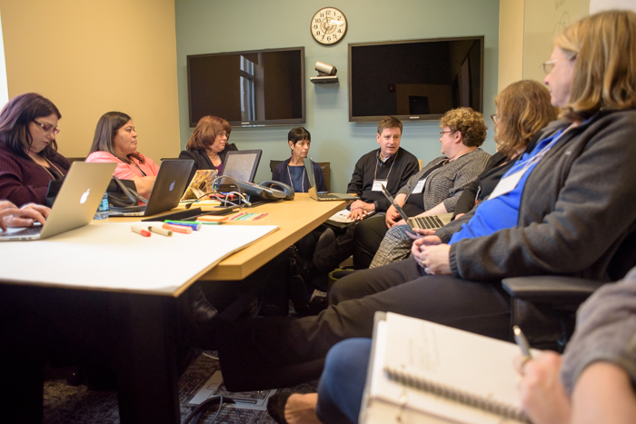 A group of individuals around a conference table.