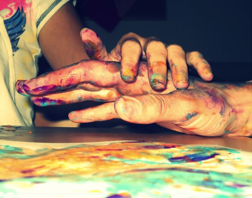 One painted hand over another.